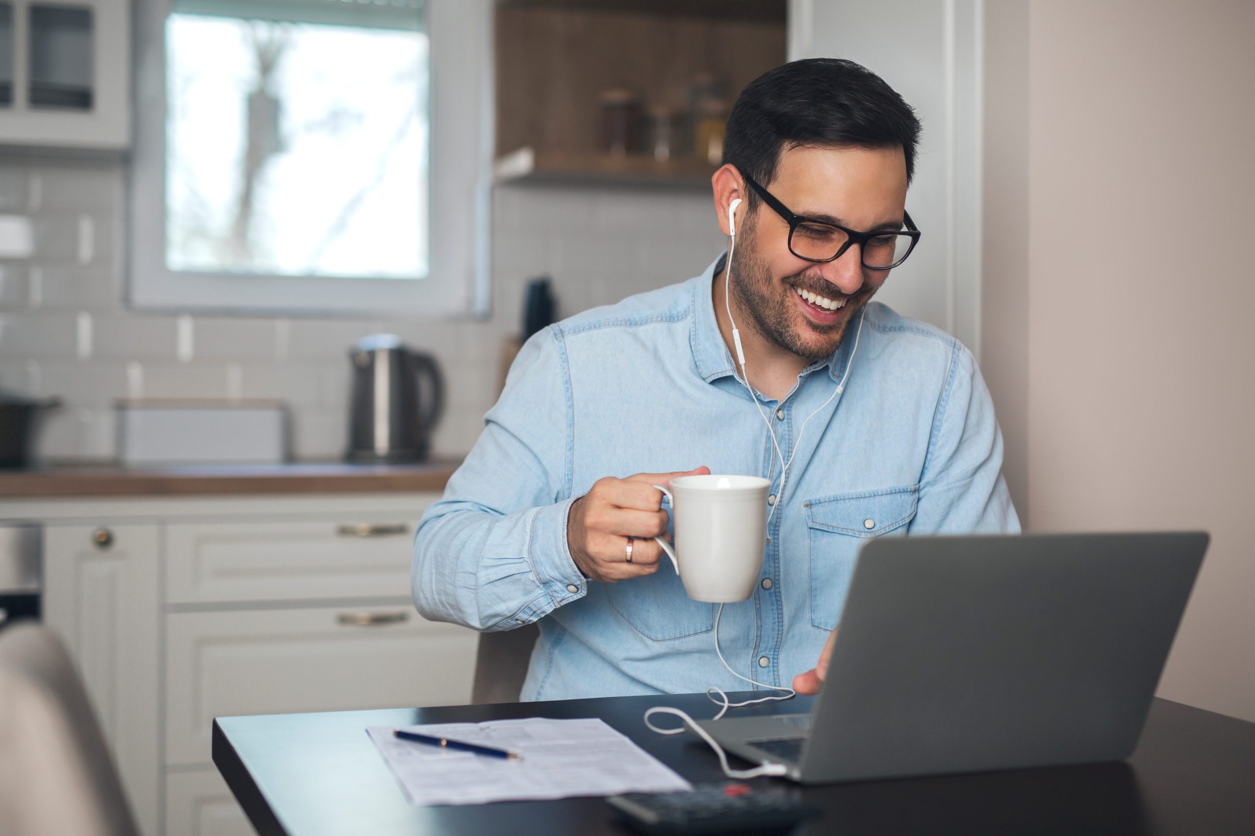 Man, managing remote workforce on computer